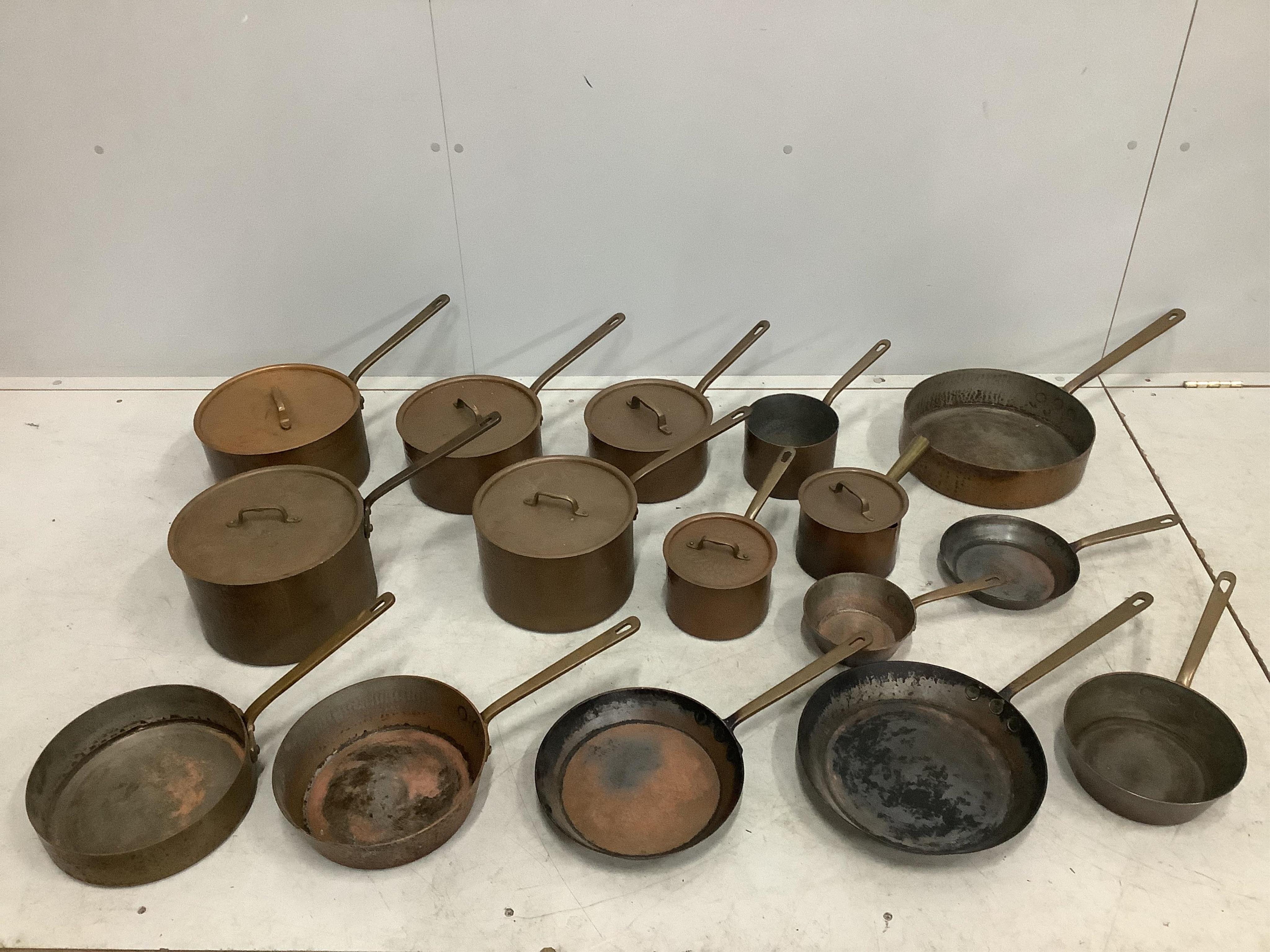 A quantity of assorted copper pans and covers. Condition - fair